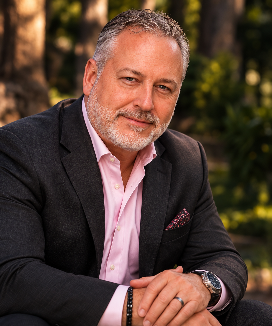David Coleman outdoors in a dark jacket and pink shirt